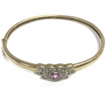 A 9ct gold bangle with a Ruby heart. 10.98g and 6.5cm diameter