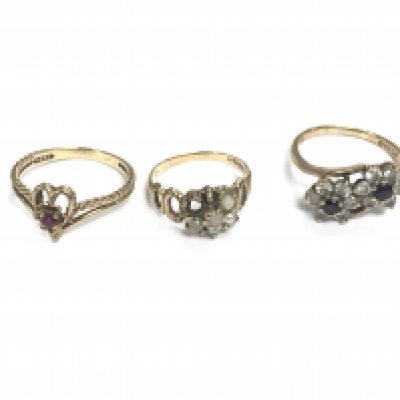 Three 9ct gold rings set with assorted stones. 6.49g total. Postage A