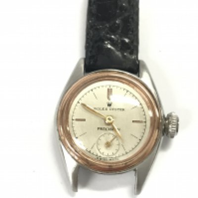 A vintage ladies Oyster Precision watch. Approximately 24mm case. Black leather strap. Comes with aftermarket box. Not seen running.