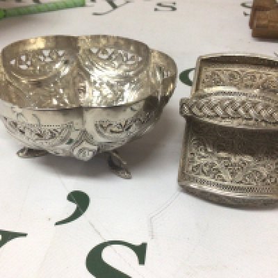 A white metal bowl stamped 90 possible Indian with Repousse decoration panels of animals and foliage. and a filigree case (2)