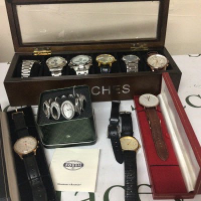 A collection of gents watches including a Henry British design Chronograph watch and other watches in a watch box.