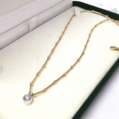An 18ct necklace set with a rub over solitaire , 10g total weight approximately .postage category A