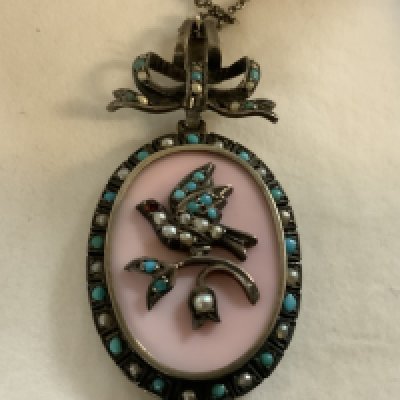 A pretty Edwardian white metal pendant inset with turquoise and seed pearls.