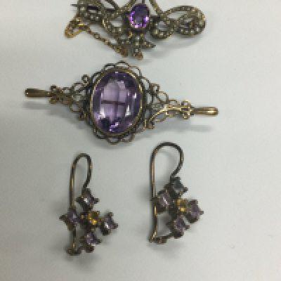Two 9 ct gold brooches inset with Amethyst and a pair of ea