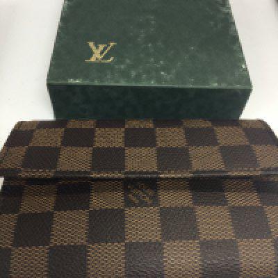A Louis Vuitton purse with original box.