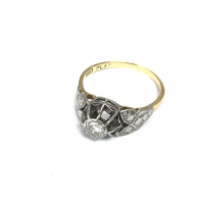 An 18ct gold and platinum diamond solitaire ring. Approximately size O and 3.36g