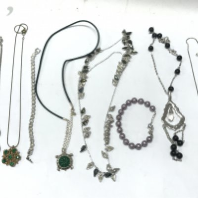 Silver coloured necklaces and bracelets with stones . Postage cat A