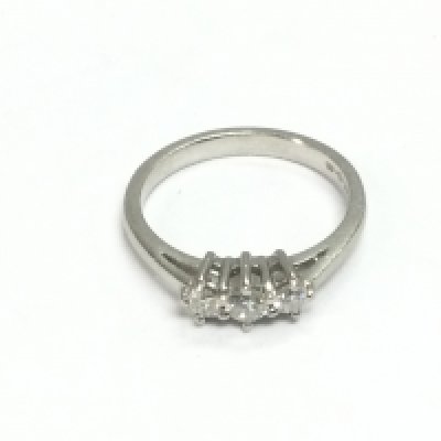 A platinum three stone diamond ring, approx size M and approx 4.6g. Shipping category A.