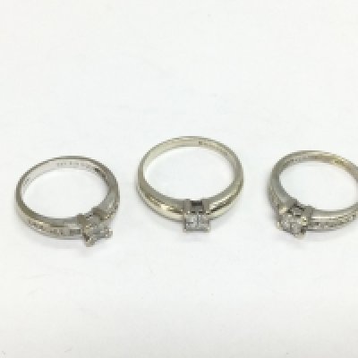 Three 9ct white gold princess cut diamond solitaire rings, approx sizes I, J and N. Total approx 7.6g. Shipping category A.