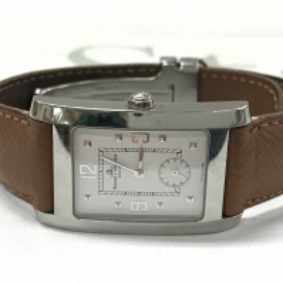 A Baume & Mercier watch in a brown leather strap . Postage category A