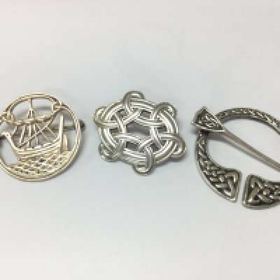 Three sterling silver Celtic brooches . Postage category A