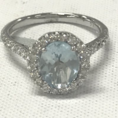 9ct white gold oval aquamarine and RBC diamond cluster ring with diamond set shoulders. Aquamarine 1.43ct. Diamonds 0.55ct.