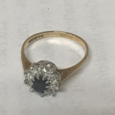 A 9 carat gold ring set with blue sapphire and diamonds. Weight 2g