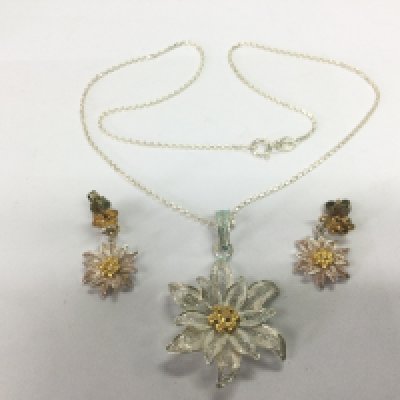 A silver filigree pendant and matching pair of earrings. Shipping category A.