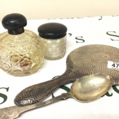 A silver backed mirror silver spoon silver mounted cut glass scent bottle and a tidy jar.