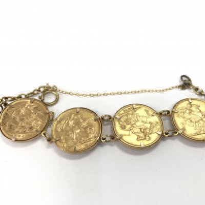 A 9ct gold bracelet containing four full sovereigns 1876 1892 1896 and 1906. 39.28g Postage B