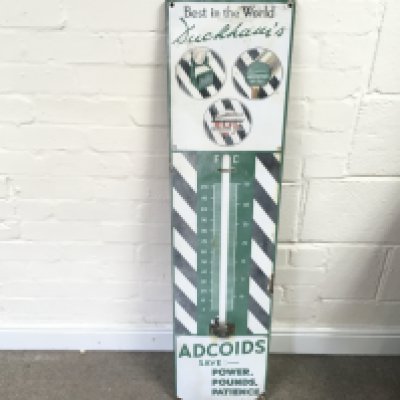 An enamel 'Duckhams Adcoids' garage thermometer No glass tube. 11 x 45 inches approximately