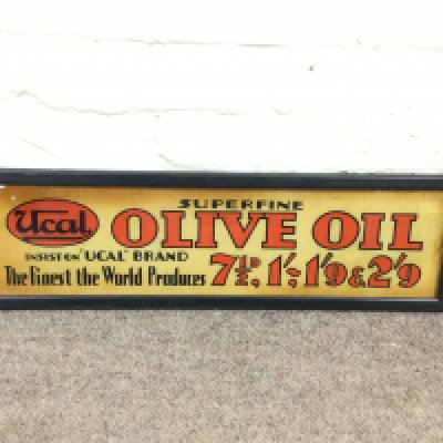A Ucal 'Superfine Olive Oil' glass advertising sign 22 x 7 inches approximately