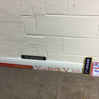 A collection of assorted small advertising signs including bovril and craven A