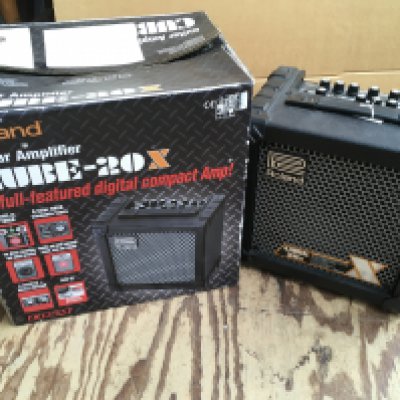 A boxed Roland Cube 20X guitar amplifier.