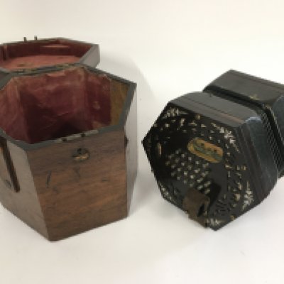 A fine quality concertina with original fitted wooden case. Label sadly illegible.