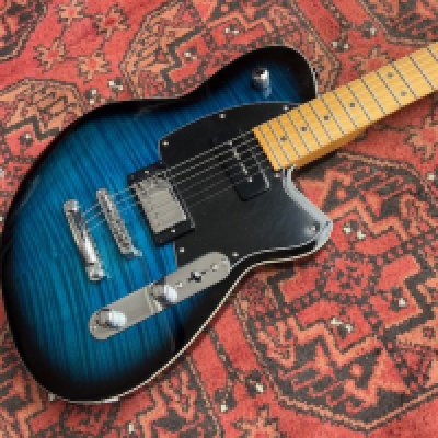 A Reverend Double Agent OG electric guitar in Blueburst with flame top, 2x humbucking, Unplayed with plastic still on pickguard and control cavity cover. Maple board and neck and board with no evidence of playwear or tarnishing to frets. Comes with non original hard case and some wear to case outer.