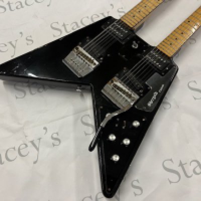 A mid 1970's Custom Built 1/1 Shergold Double Neck Electric Guitar. 12 string over 6 string with the custom V shape body requested by a customer. Maple neck and fingerboard. All original custom made Shergold parts including custom made fulcrum made vibrate on the 6 string side, custom wound Shergold pickups and Schiller tuners. In good overall condition consistent with age and use and these having been part of the guitar collection of a touring musician. Comes with Custom made plywood case apparently constructed by Shergold to house the guitar. Case is in fair condition with wear to the outer.