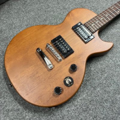 An Epiphone Vintage Edition in walnut finish. Brand new still in packaging. Only taken out of original packaging for catalogue photograph and salesroom display,