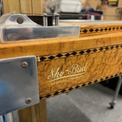 This is an all original 1970's Sho Bud Pro II Custom Pedal Steel Guitar in very good condition. It comes with a hard case and tutor books, slides and picks. Birds Eye maple veneer finish and "Gambler" pack of card design position markers. Pedal assembly in chrome with rods. This is a top of the range Nashville USA manufactured pedal steel in very good condition. Will require a restring and set up to the individual player's personal specification.