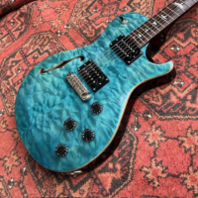 A PRS SE Zakk Myers semi solid electric guitar in Turquoise and Flame Maple Top Rosewood Board with Birds. 2 x Humbucking pickups. Come with Stop Tailpiece. Made in Korea. The guitar is in generally good overall condition with some evidence of use and playwear and a small chip to headstock. Comes with PRS Gigbag