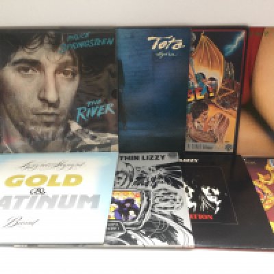 Two bags containing 16 rock LPs by various artists including Thin Lizzy, Bruce Springsteen, Montrose and others.