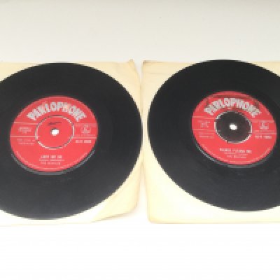 Two early UK pressings of Beatles 7" singles comprising red label issues of 'Love Me Do' and 'Please Please Me'. Both with Made in Gt Britain label text and The Parlophone Co Ltd rim text. ZT tax code for 'Love Me Do' indicating a pre November 1962 pressing. Scratch to the run out grooves on side A, writing and pen marks on label for Love Me Do. No scratches on Please Please Me but similar writing and pen marks to label.