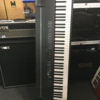 A boxed Roland FP-7 digital piano and stand (2).