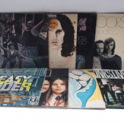 Two bags containing 16 rock LPs by various artists including The Doors, The Kinks, Pink Floyd, T Rex and others plus a pink vinyl 12" single by The Rolling Stones. Includes many German pressings.