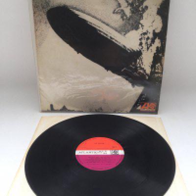 An early UK mispressing of Led Zeppelin I on red/plum Atlantic labels, grey stripe along bottom of front cover. Has Side Two labels affixed to both sides of the disc. Vinyl Ex but needs a clean.