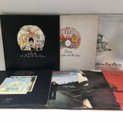 Seven rock LPs by various artists including Queen, Led Zeppelin and others.