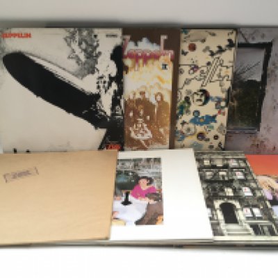 Two bags containing 16 Led Zeppelin and solo LPs and 12" singles, no red/plum Atlantic labels, comprising all of their studio albums from 'Led Zep 1' to 'Coda' plus various Robert Plant LPs and 12" singles.