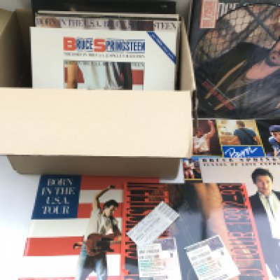 A bag of Bruce Springsteen LPs, 12" singles, concert programmes and tickets including a 5LP 'Live 1975-85' box set.