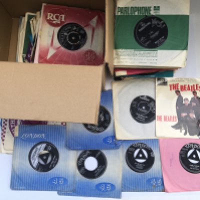 A box of 7" singles and EPs by various artists from the 1950s onwards including Little Richard, Larry Williams, Elvis Presley, The Beatles and many more.