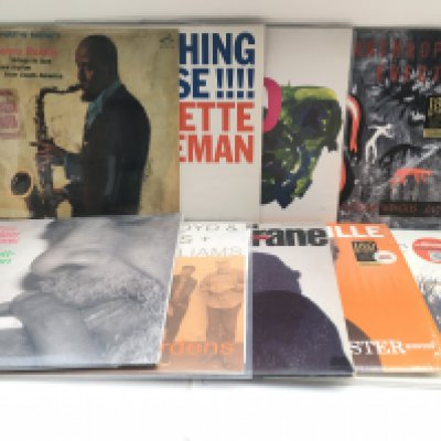 A box of jazz LPs by various artists including Sonny Rollins, Charles Mingus, Gill Scott-Heron and many more. Includes original and 180g reissues.