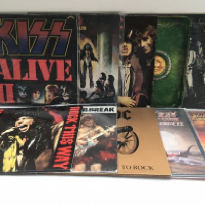 A collection of heavy rock LPs and 12" singles by various artists including Kiss, AC/DC, Alice Cooper, Ozzy Osbourne and others.