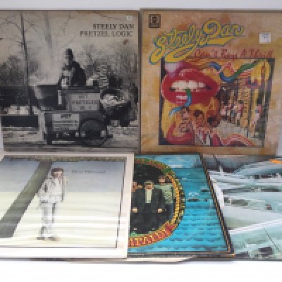 Two bags containing 15 rock & pop LPs by various artists including Steve Winwood, Steely Dan, Foreigner and others.