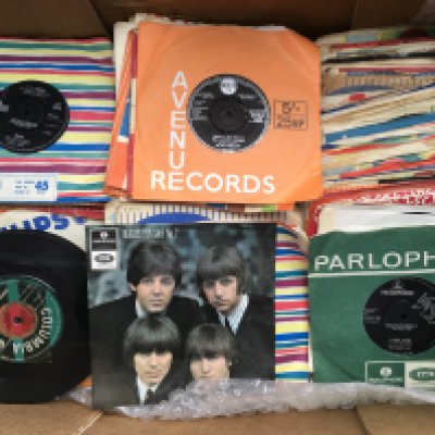 A collection of 7" singles and EPs by various artists including The Beatles, The Shadows, Elvis Presley and others.