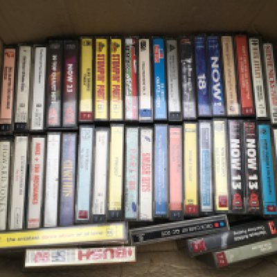 A box of audio cassettes by various artists including Queen, Peter Gabriel and others.