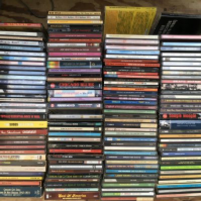A box of over 140 CDs by various artists including The Beatles, Rolling Stones, Led Zeppelin and others.