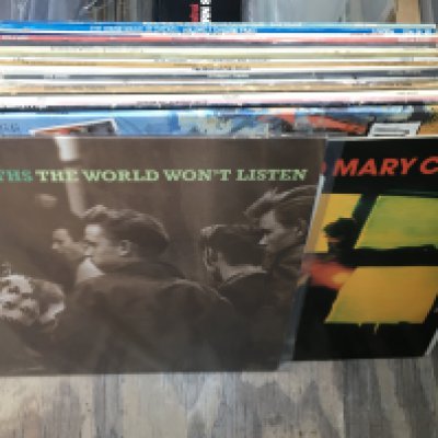 A bag of LPs and 12" singles by various artists including The Smiths, Jesus And Mary Chain and others.