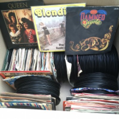 A box of 7" singles and EPs by various artists including Elvis Presley, The Who, The Rolling Stones and many more.