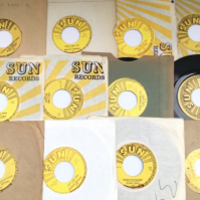 A collection of 23 Sun label 7" singles by various artists including Jerry Lee Lewis, Elvis Presley, Carl Perkins and others.