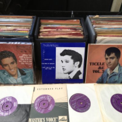 Three record cases of Elvis Presley 7" singles and EPs including purple / silver HMV labels.