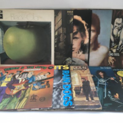 Two bags containing 20 rock LPs by various artists including David Bowie, Jeff Beck, Frank Zappa, Tom Waits and others.